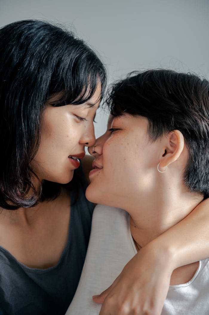 about-02 Intimate portrait of a couple sharing a close, loving moment indoors.